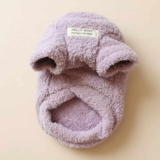 Fluffy pink baby hat with 'Hello Baby' label on a white background