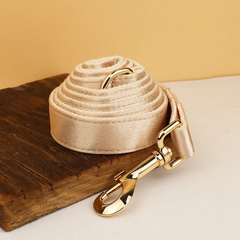 Pamper your pup with the Golden Luxe Silky Dog Set. Personalized bow, collar, leash, and harness in luxurious gold for an elegant, custom look. leash rolled up gold color