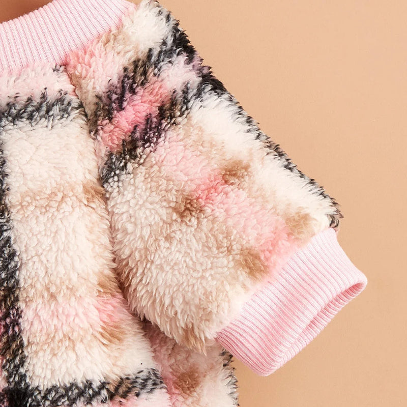 Wrap your small dog in style and comfort with our Cozy Chic Woolen Sweater. Perfect for Chihuahuas, Schnauzers, and puppies, this fleece pullover is a must-have for cooler weather walks. Plaid Pink detail