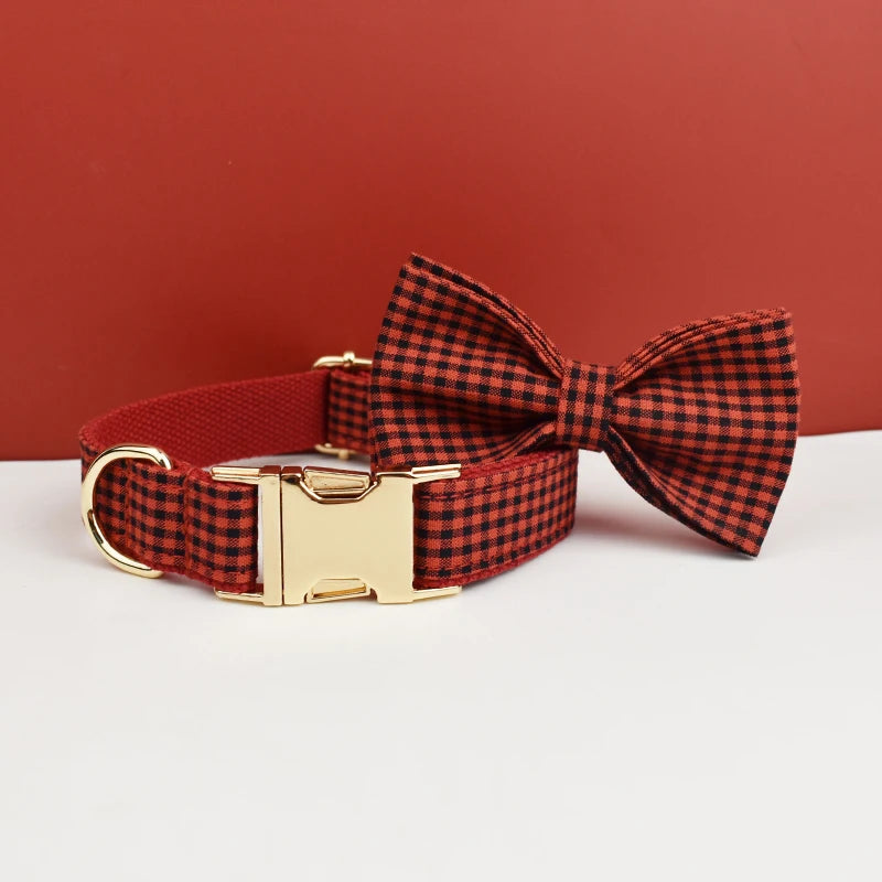 Add timeless elegance to your dog’s look with the Luxury Plaid Bow Tie Collar Collection. Premium quality, stylish plaid patterns, and detachable bow ties for versatile charm. dark red plaid-ish style bow to the right collar on tabletop