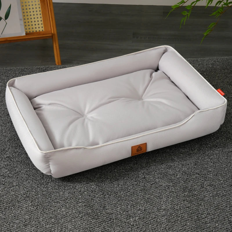 A white rectangular dog bed made of waterproof Oxford fabric, featuring a thickened cotton padding and a visible brand tag.