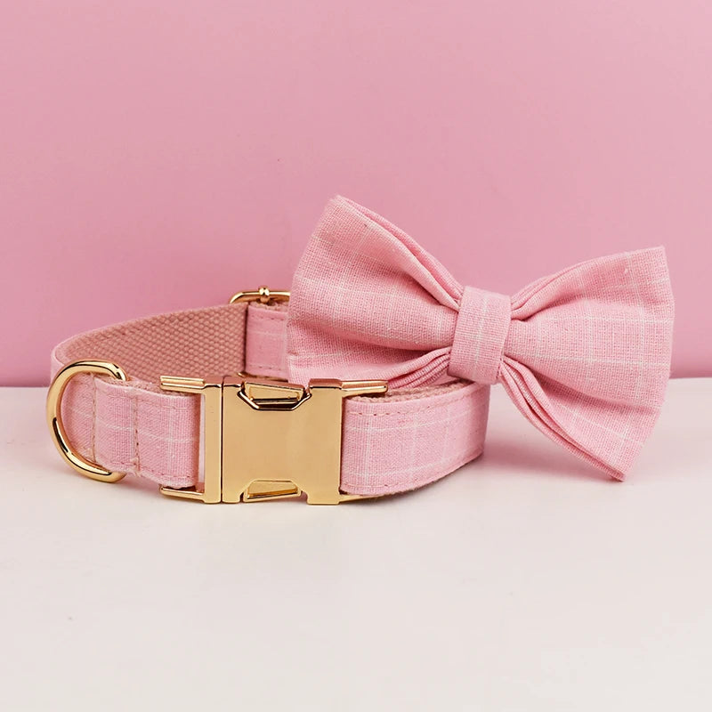 Add timeless elegance to your dog’s look with the Luxury Plaid Bow Tie Collar Collection. Premium quality, stylish plaid patterns, and detachable bow ties for versatile charm. pinkplaid bow to the right collar flat on the table