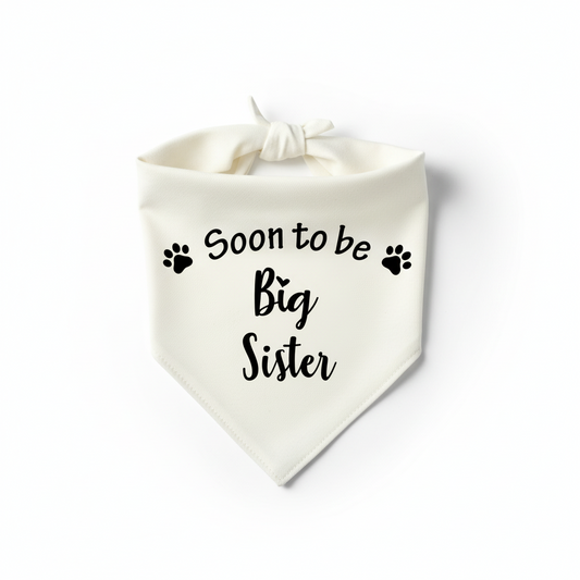 A white pet bandana with the text 'Soon to be Big Sister' printed in black, featuring paw prints as decorative elements.