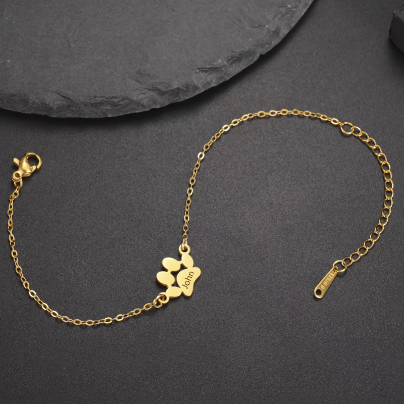 Gold bracelet with a clasp on a dark gray background