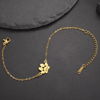 Gold bracelet with a clasp on a dark gray background