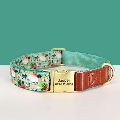Dog collar with floral pattern, gold buckle, and engraved nameplate on a teal background