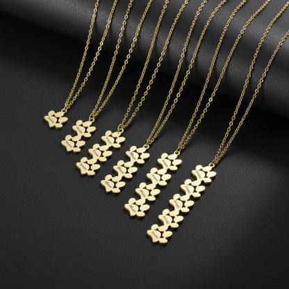 Show your love for your pet with the Personalized Stainless Steel Paw Print Necklace. Custom engraved and elegantly designed for a timeless, lasting keepsake. display of 5 necklaces between 1 and 5 paws