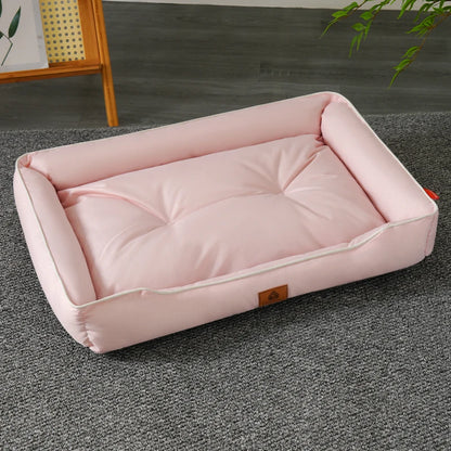 A pink waterproof dog bed made of Oxford fabric, placed on a gray floor.