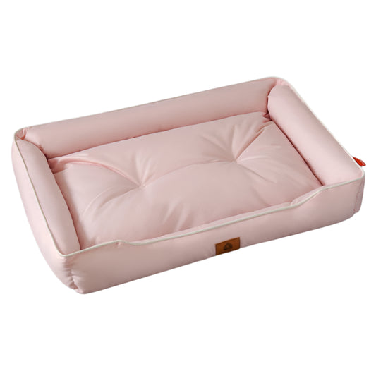 Pink pet bed on a gray floor with a plant in the background