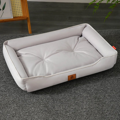 A white rectangular dog bed made of waterproof Oxford fabric, featuring a thickened cotton padding and a visible brand tag.